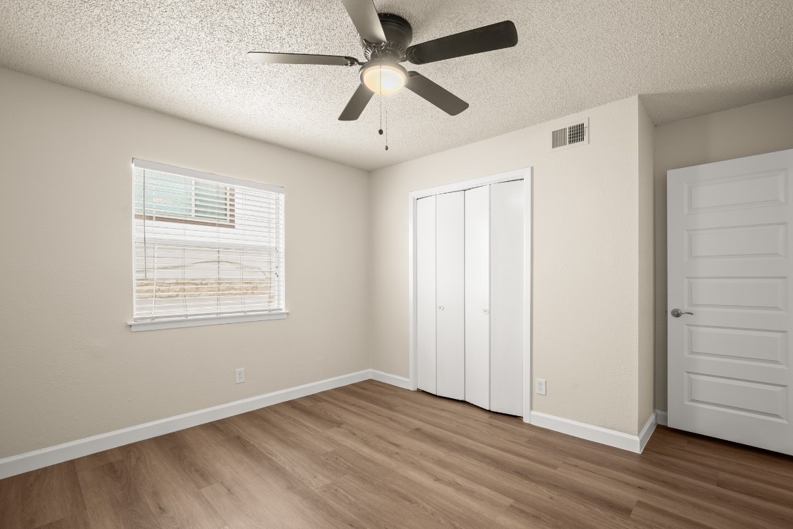 2408 Longview Street, Unit 112 Austin, TX 78705 - Photo 14 of 15 a view of an empty room with wooden floor and a window