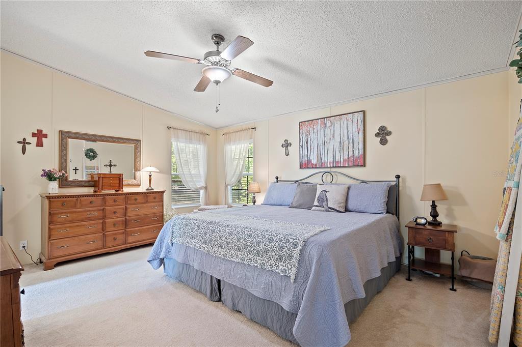 159 Southwest 70th Avenue Bell, FL 32619 - Photo 11 of 42 a bedroom with a bed and a chandelier