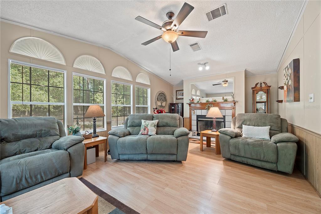 159 Southwest 70th Avenue Bell, FL 32619 - Photo 2 of 42 a living room with furniture ceiling fan and a large window