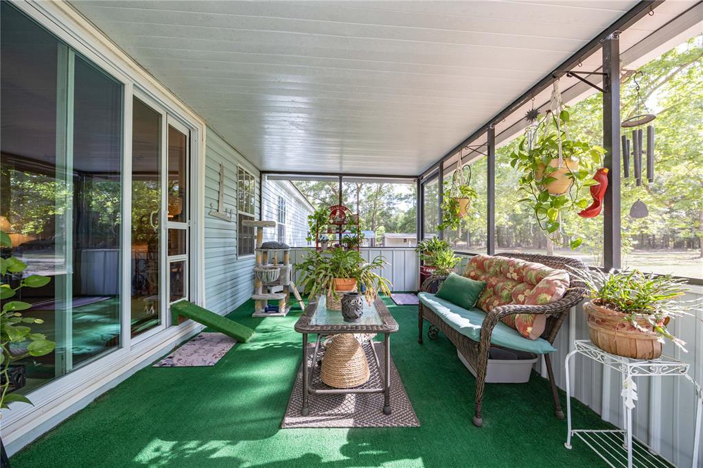 159 Southwest 70th Avenue Bell, FL 32619 - Photo 21 of 42 a patio with table and chairs potted plants and large tree