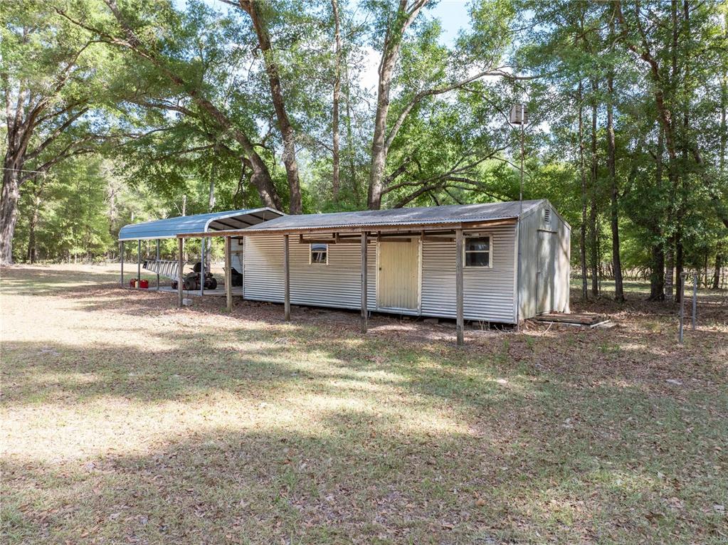 159 Southwest 70th Avenue Bell, FL 32619 - Photo 26 of 42 a view of a house with a backyard and a tree