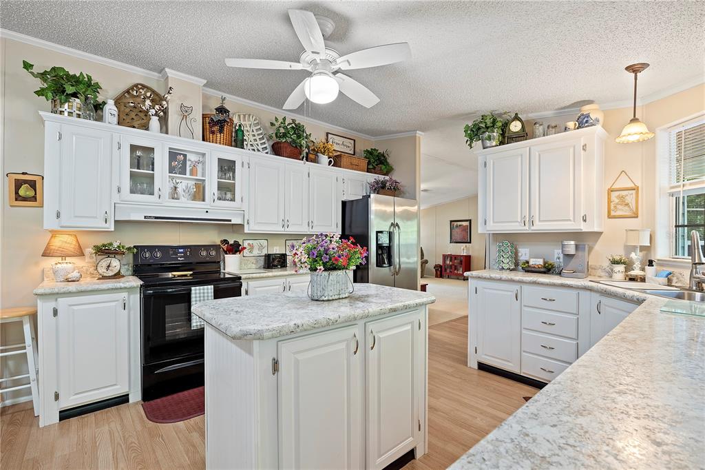 159 Southwest 70th Avenue Bell, FL 32619 - Photo 4 of 42 a kitchen with stainless steel appliances granite countertop a stove and cabinets