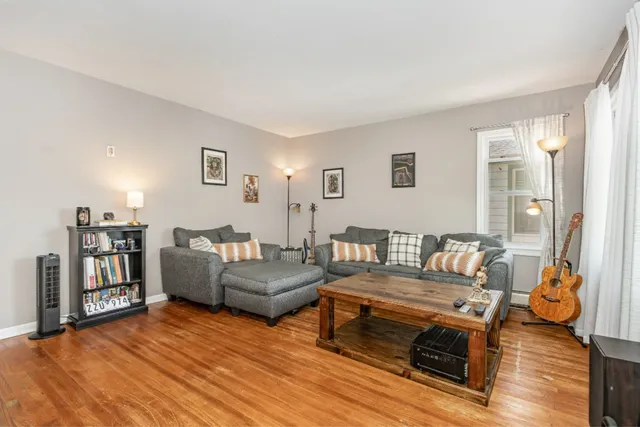 a living room with furniture and a wooden floor