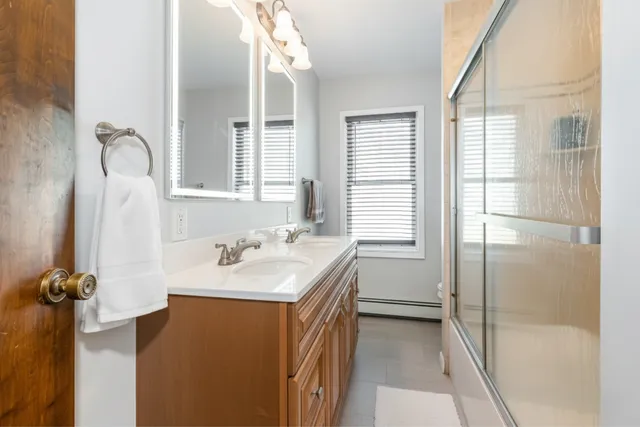 a bathroom with a sink a toilet and shower