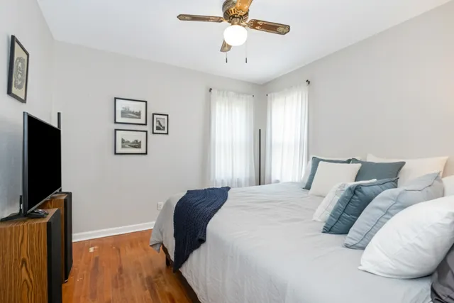 a bedroom with a bed and a flat screen tv