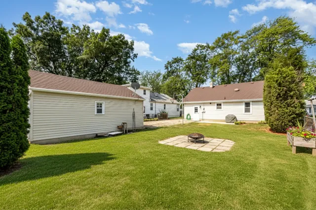 a view of a house with a yard and a tree