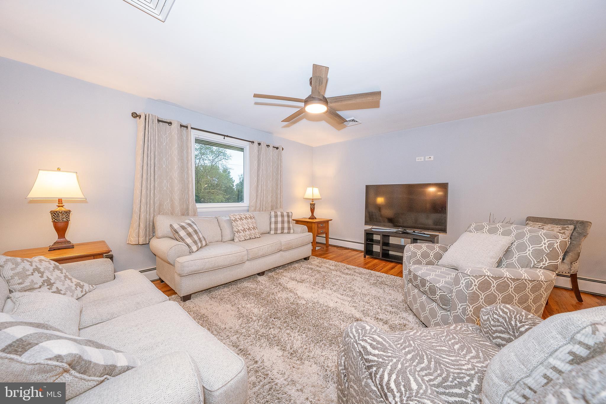 950 Spring City Road Phoenixville, PA 19460 - Photo 19 of 43 a living room with furniture a flat screen tv and a couch