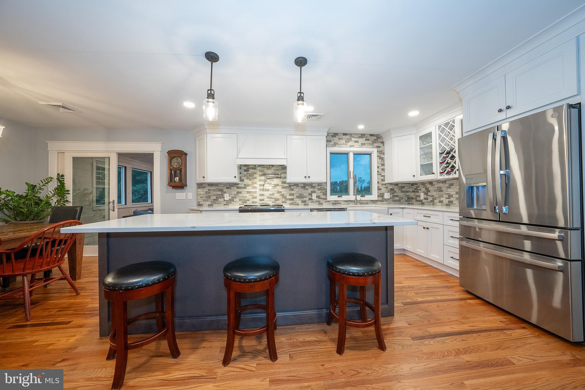 950 Spring City Road Phoenixville, PA 19460 - Photo 2 of 43 a kitchen with stainless steel appliances granite countertop a refrigerator a stove a sink a dining table and chairs with wooden floor