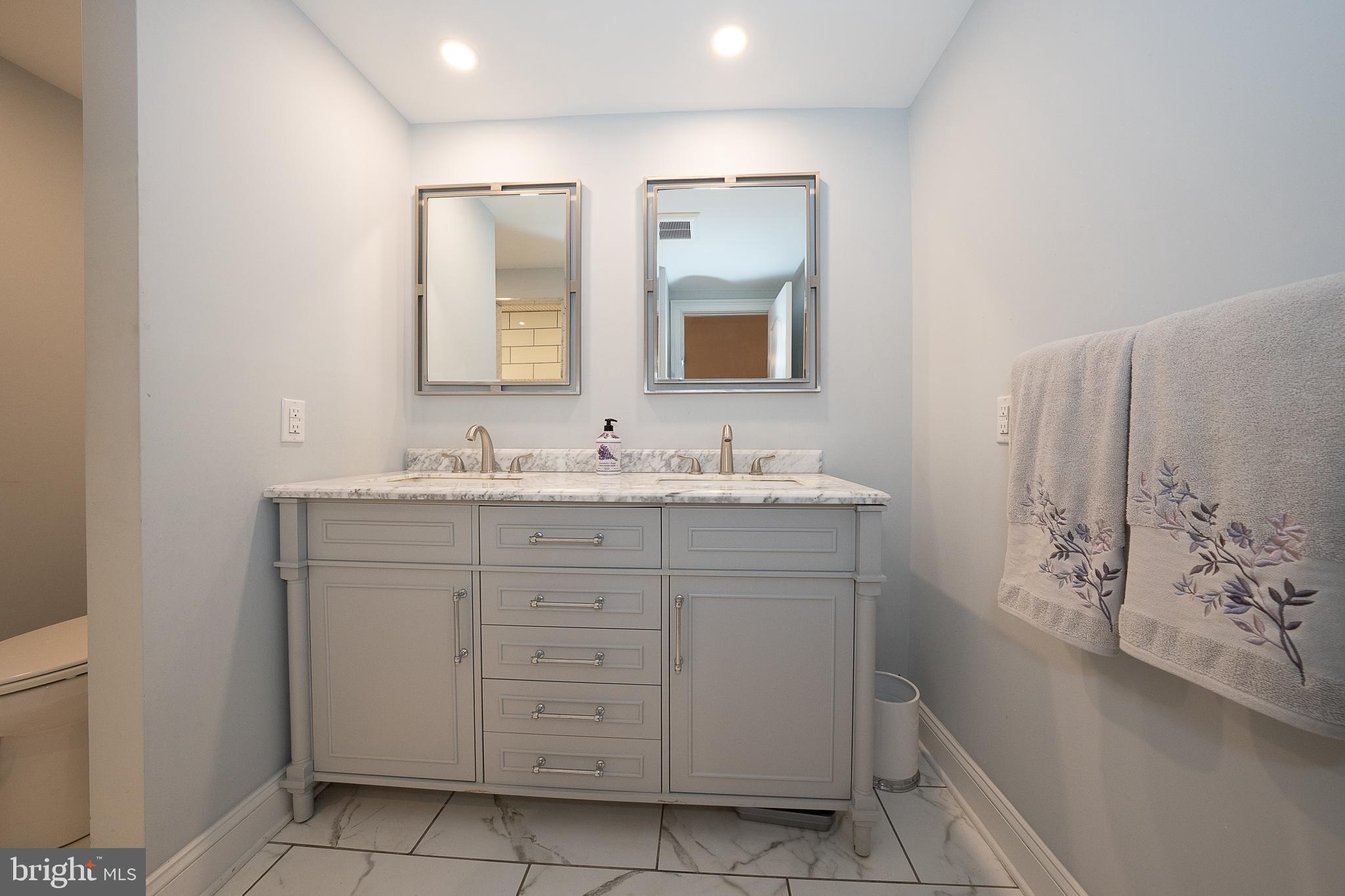 950 Spring City Road Phoenixville, PA 19460 - Photo 25 of 43 a bathroom with a sink double vanity and mirror