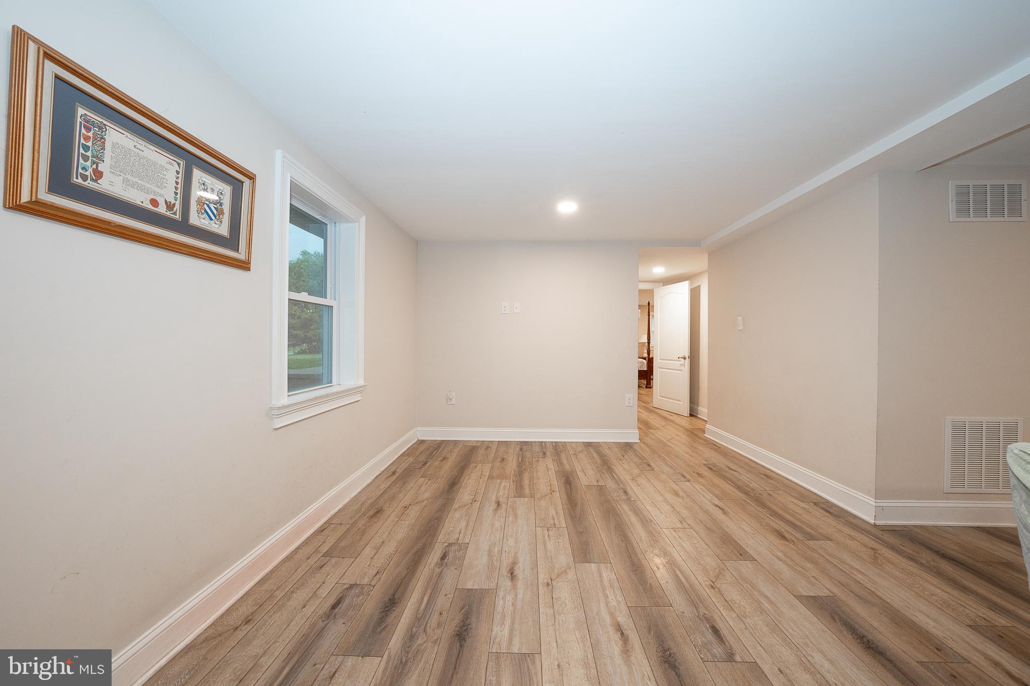 950 Spring City Road Phoenixville, PA 19460 - Photo 28 of 43 a view of an empty room with wooden floor and a window