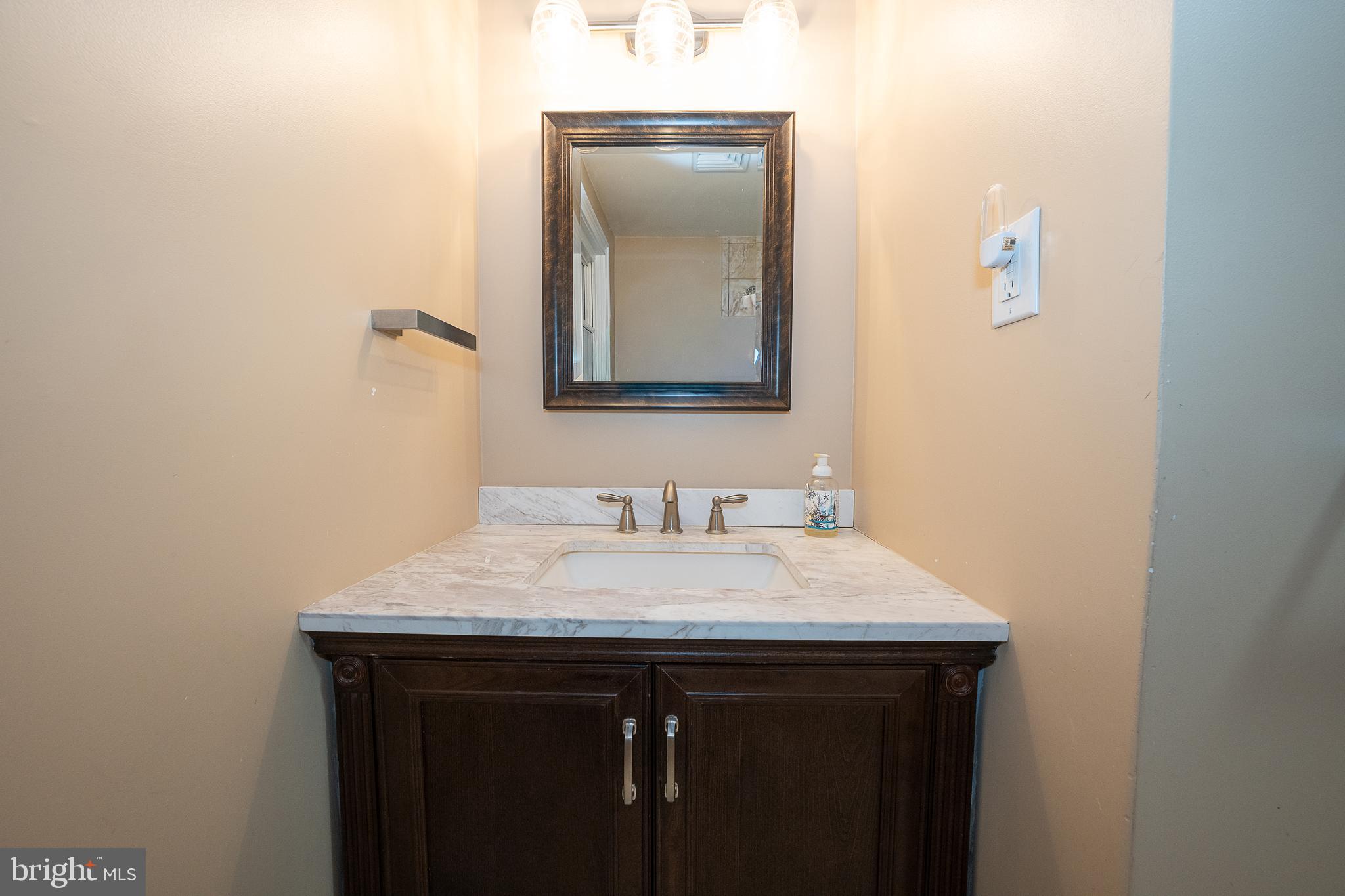 950 Spring City Road Phoenixville, PA 19460 - Photo 37 of 43 a bathroom with a sink vanity and mirror