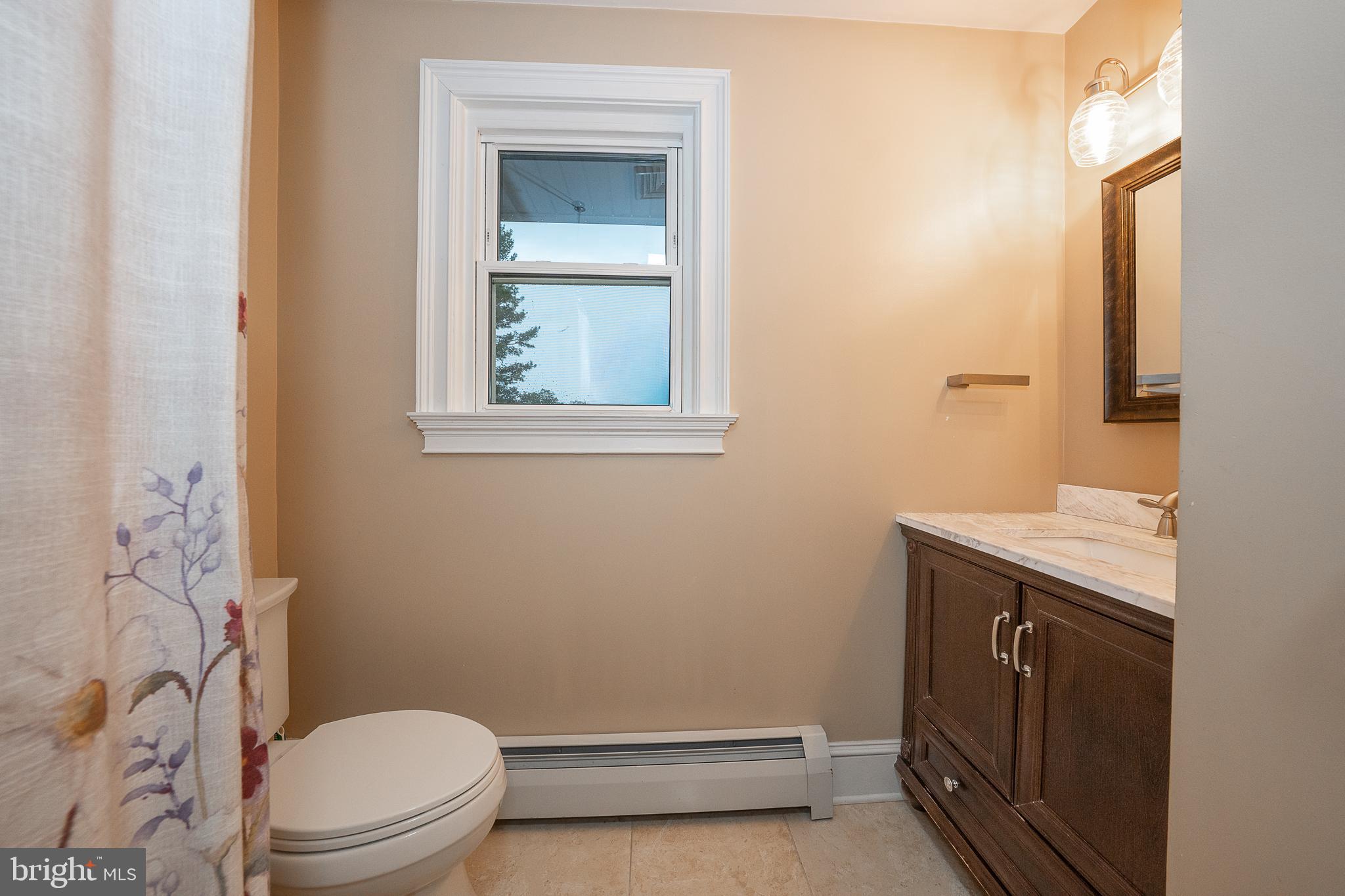 950 Spring City Road Phoenixville, PA 19460 - Photo 38 of 43 a bathroom with a granite countertop toilet sink and mirror