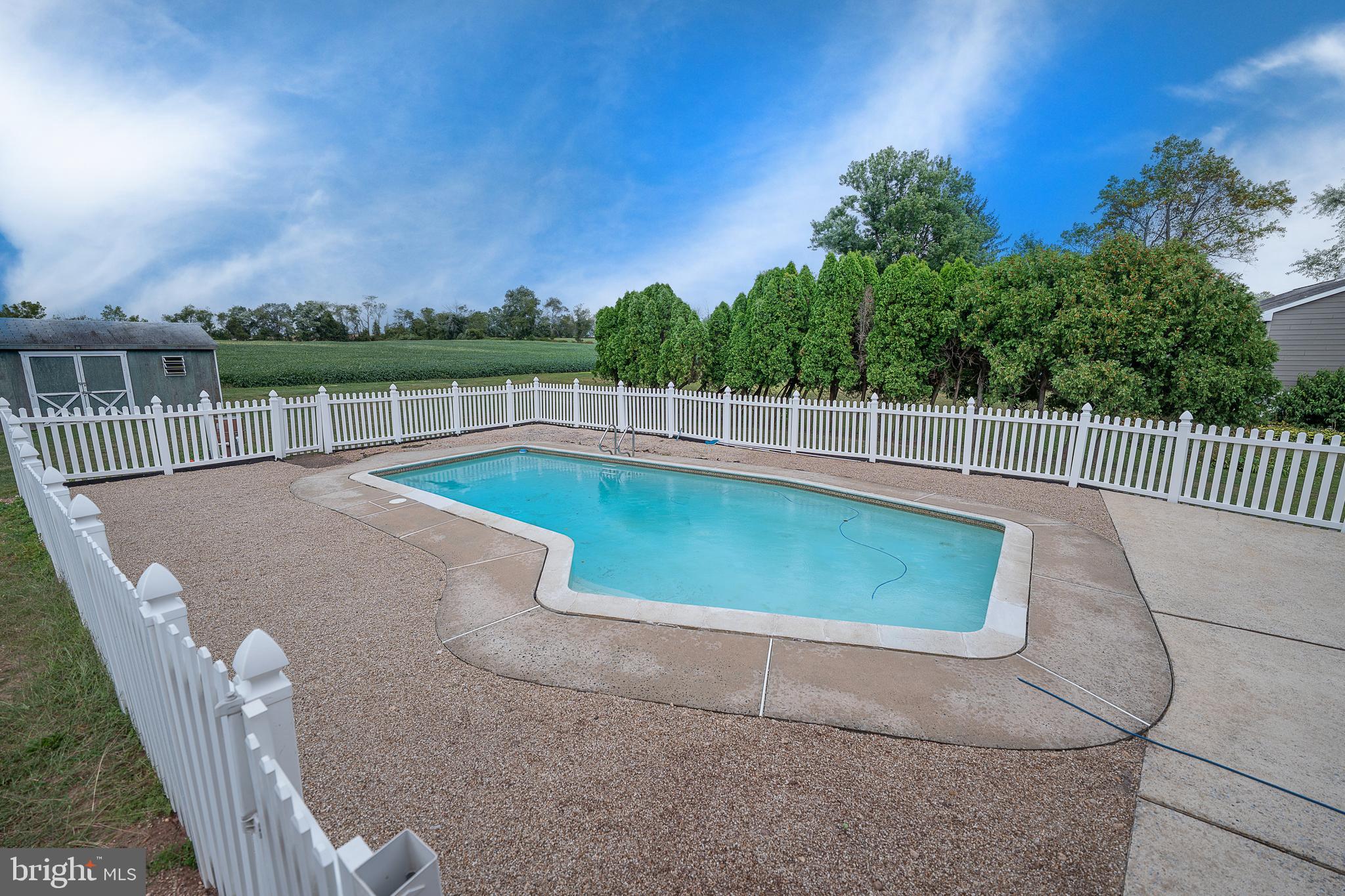 950 Spring City Road Phoenixville, PA 19460 - Photo 43 of 43 a view of a swimming pool with a patio and a yard