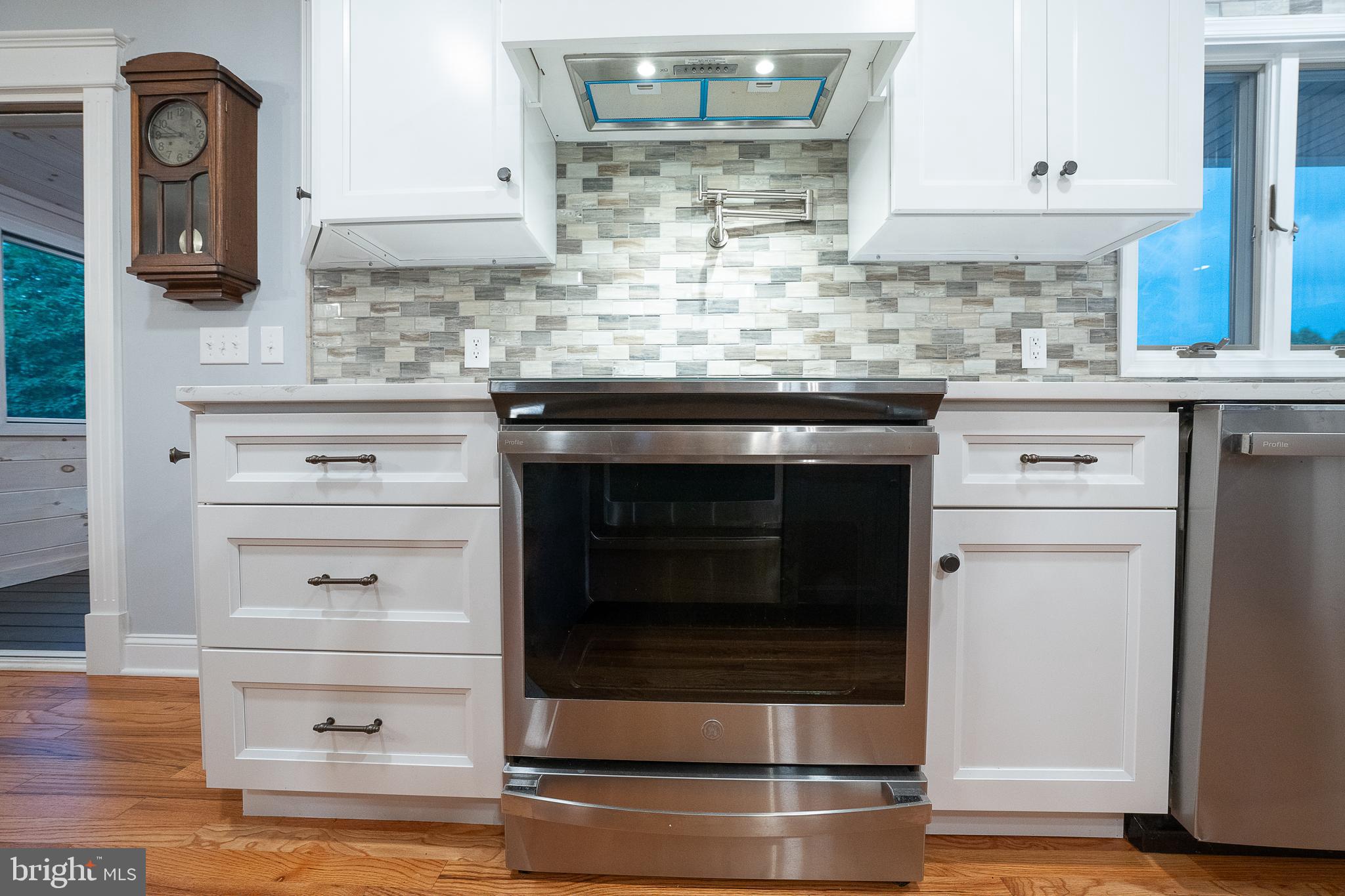 950 Spring City Road Phoenixville, PA 19460 - Photo 5 of 43 a kitchen with granite countertop white cabinets and stainless steel appliances