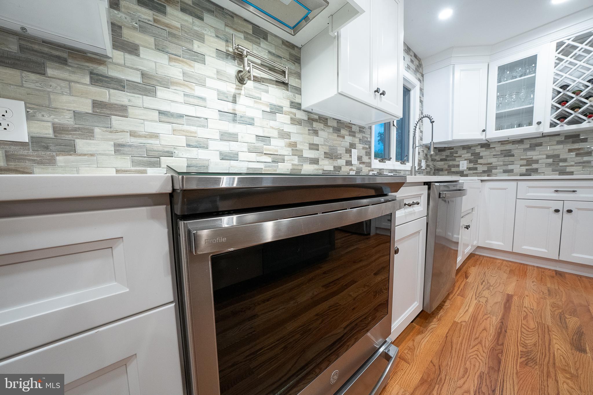 950 Spring City Road Phoenixville, PA 19460 - Photo 8 of 43 a kitchen with granite countertop stainless steel appliances and wooden cabinets