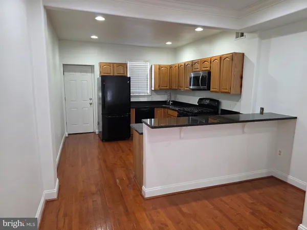 a kitchen with a refrigerator and a sink
