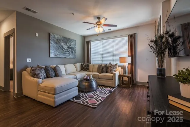 a living room with furniture and a large window