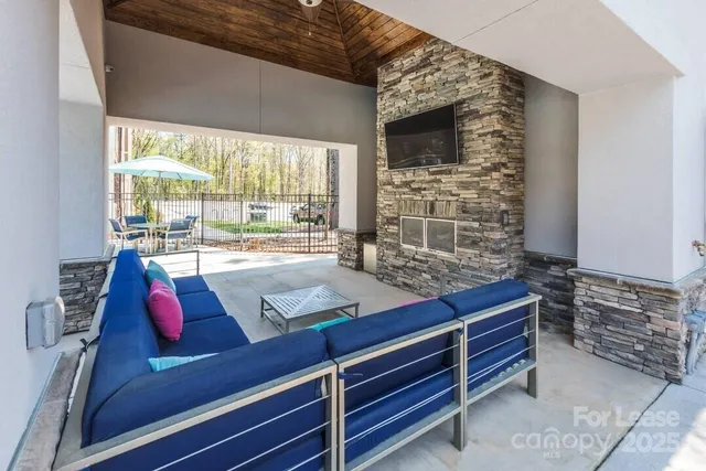 a living room with couches bookshelf and a flat screen tv