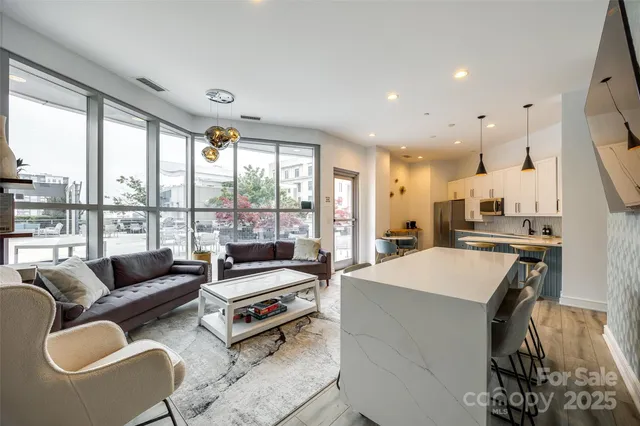 a kitchen with stainless steel appliances kitchen island granite countertop a sink and cabinets