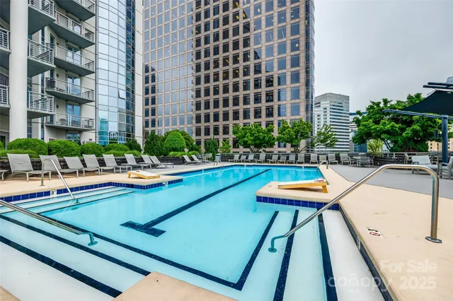 a view of a swimming pool with outdoor seating