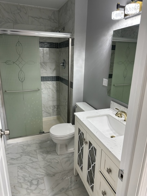 277 Armstrong Drive Buffalo Grove, IL 60089 - Photo 12 of 19 a bathroom with a sink a toilet and shower