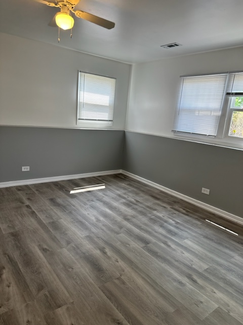 277 Armstrong Drive Buffalo Grove, IL 60089 - Photo 13 of 19 an empty room with wooden floor and windows