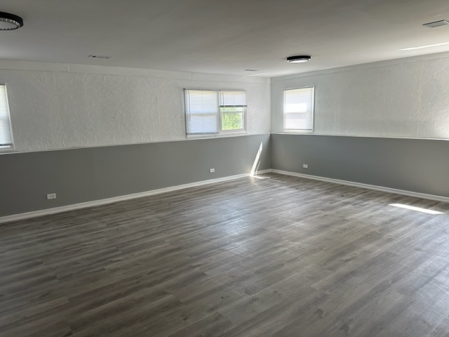 277 Armstrong Drive Buffalo Grove, IL 60089 - Photo 14 of 19 an empty room with wooden floor and windows