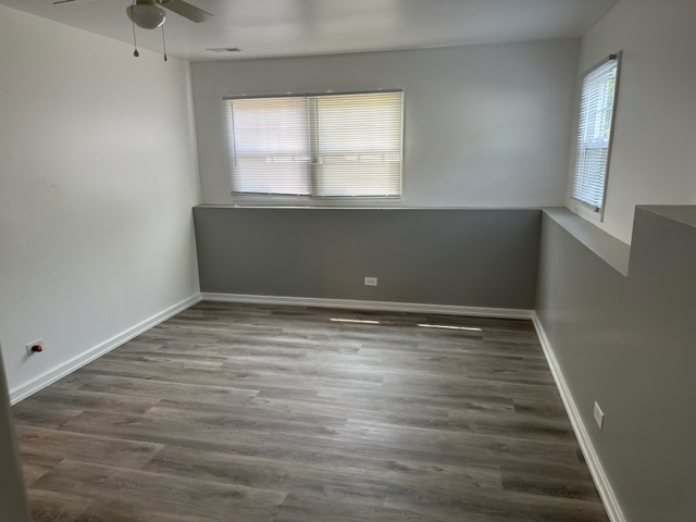 277 Armstrong Drive Buffalo Grove, IL 60089 - Photo 15 of 19 wooden floor in an empty room with a window