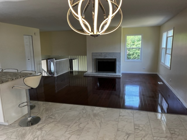 277 Armstrong Drive Buffalo Grove, IL 60089 - Photo 5 of 19 a living room with furniture and a fireplace