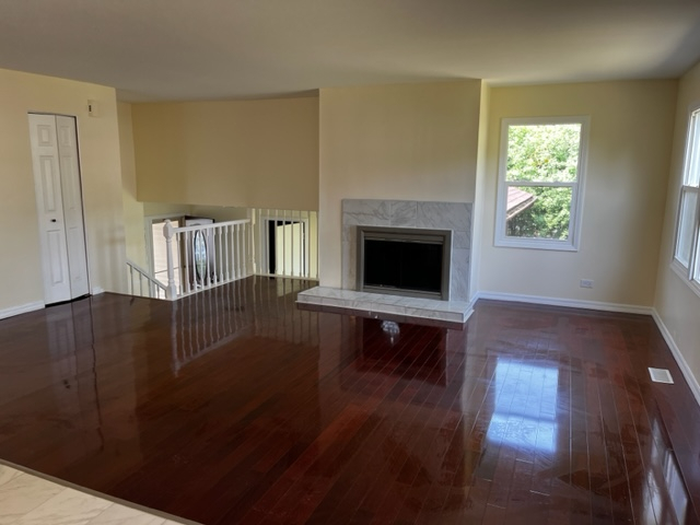 277 Armstrong Drive Buffalo Grove, IL 60089 - Photo 8 of 19 a living room with furniture and a fireplace