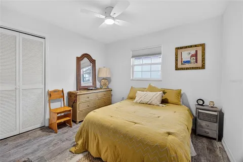 a bedroom with a bed and a tv on the dresser