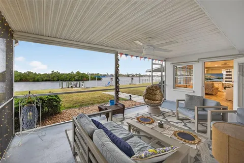 a view of a balcony with lake view and a patio