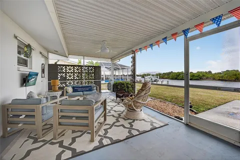 a view of a patio with chairs and table potted plants with wooden floor
