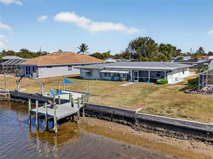 an aerial view of a house with swimming pool having outdoor seating