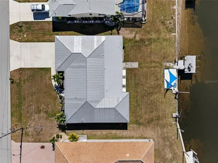 an aerial view of residential house with parking