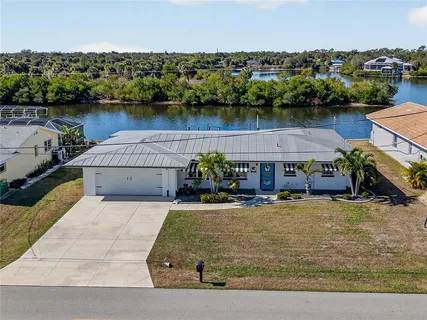 an aerial view of a house with a lake view
