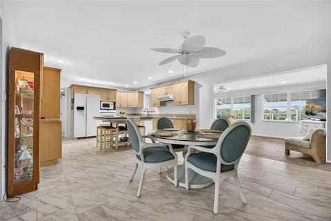 a view of a dining room with furniture and a large window
