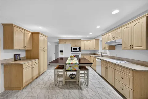 a open kitchen with sink cabinets and wooden floor