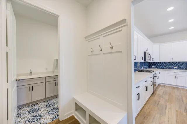 a kitchen with cabinets and wooden floor