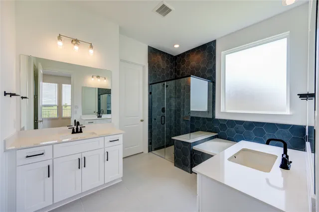 a bathroom with a double vanity sink mirror and double
