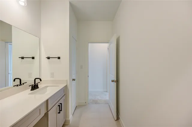 a view of a bathroom with a sink and mirror