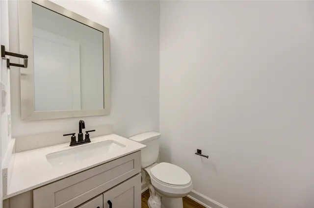 a bathroom with a sink a toilet and mirror