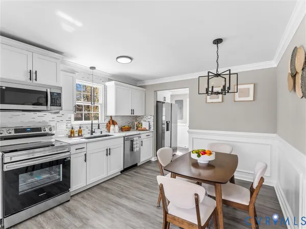 a kitchen with a stove a sink and a refrigerator