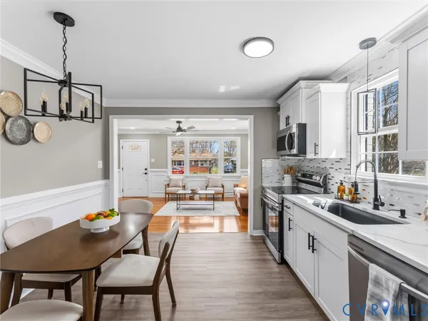 a large kitchen with a table and chairs