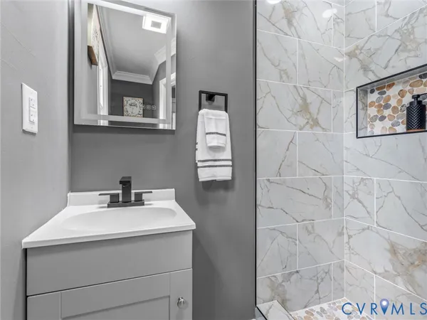 a bathroom with a sink mirror and vanity