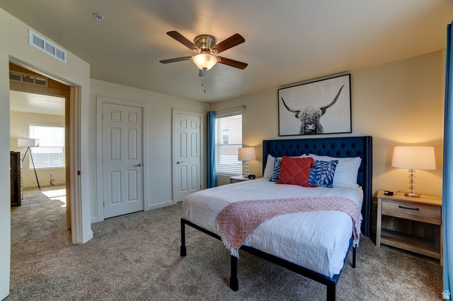 3853 South Red Valley Circle, Unit 22A1 Moab, UT 84532 - Photo 14 of 28 Bedroom with two closets, carpet floors, and a ceiling fan