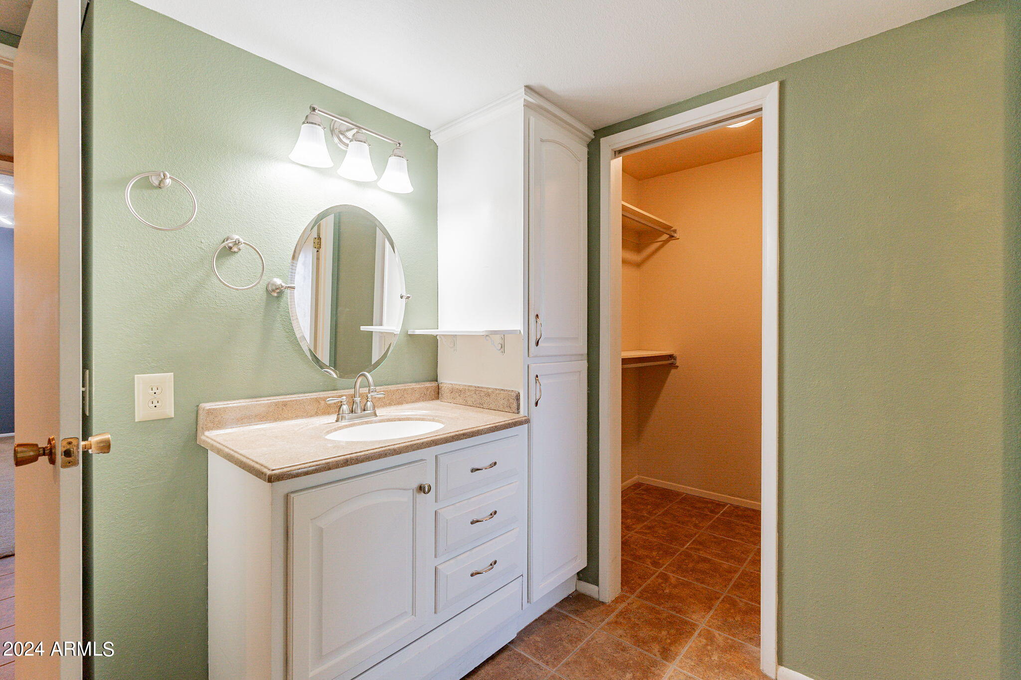 9510 West Greenway Road Sun City, AZ 85351 - Photo 15 of 46 a bathroom with a granite countertop sink and a mirror