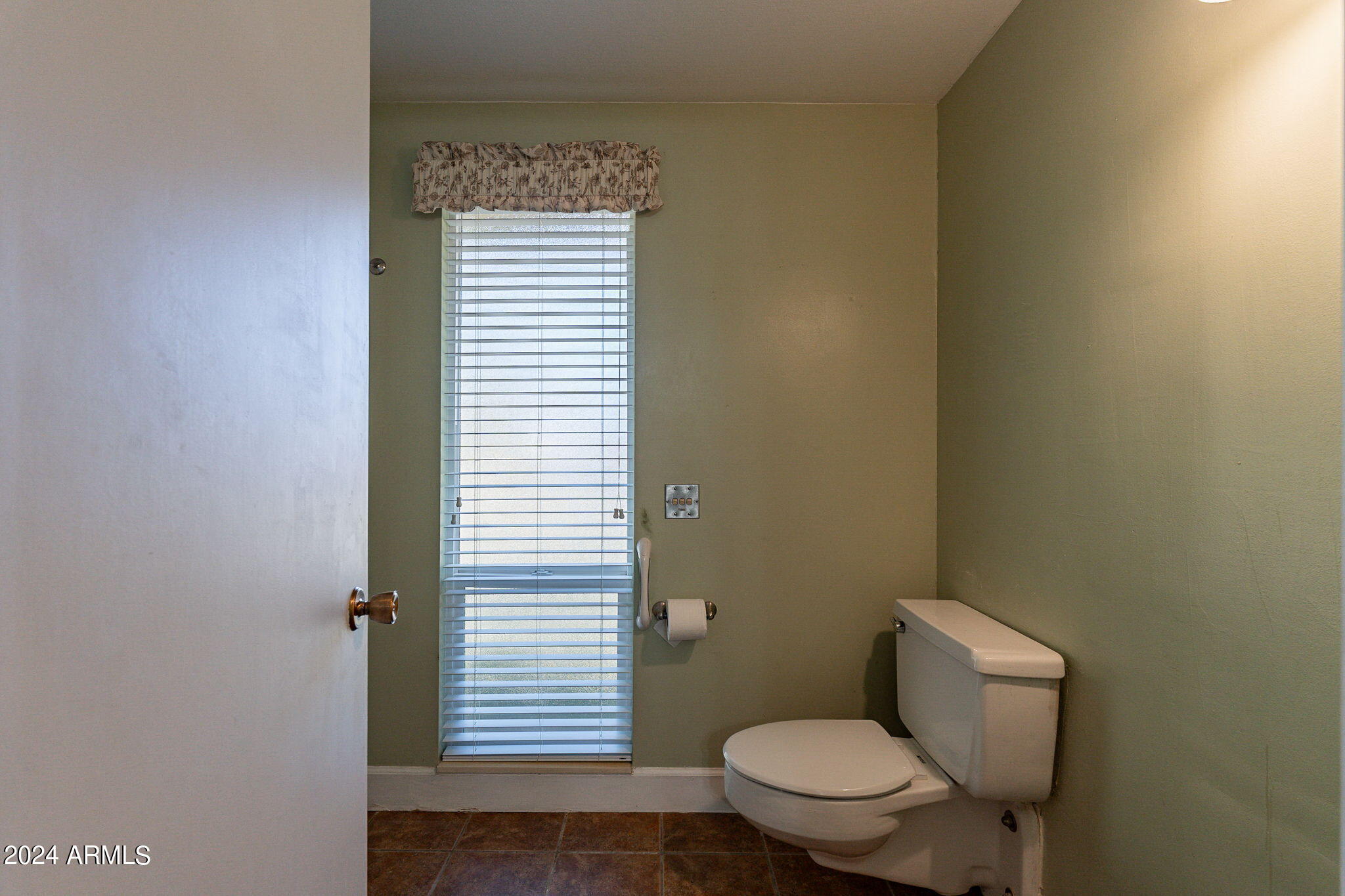 9510 West Greenway Road Sun City, AZ 85351 - Photo 17 of 46 a white toilet sitting next to a shower