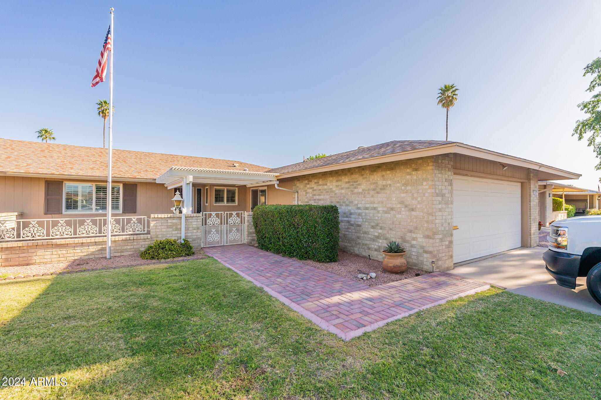 9510 West Greenway Road Sun City, AZ 85351 - Photo 3 of 46 a front view of a house with garden