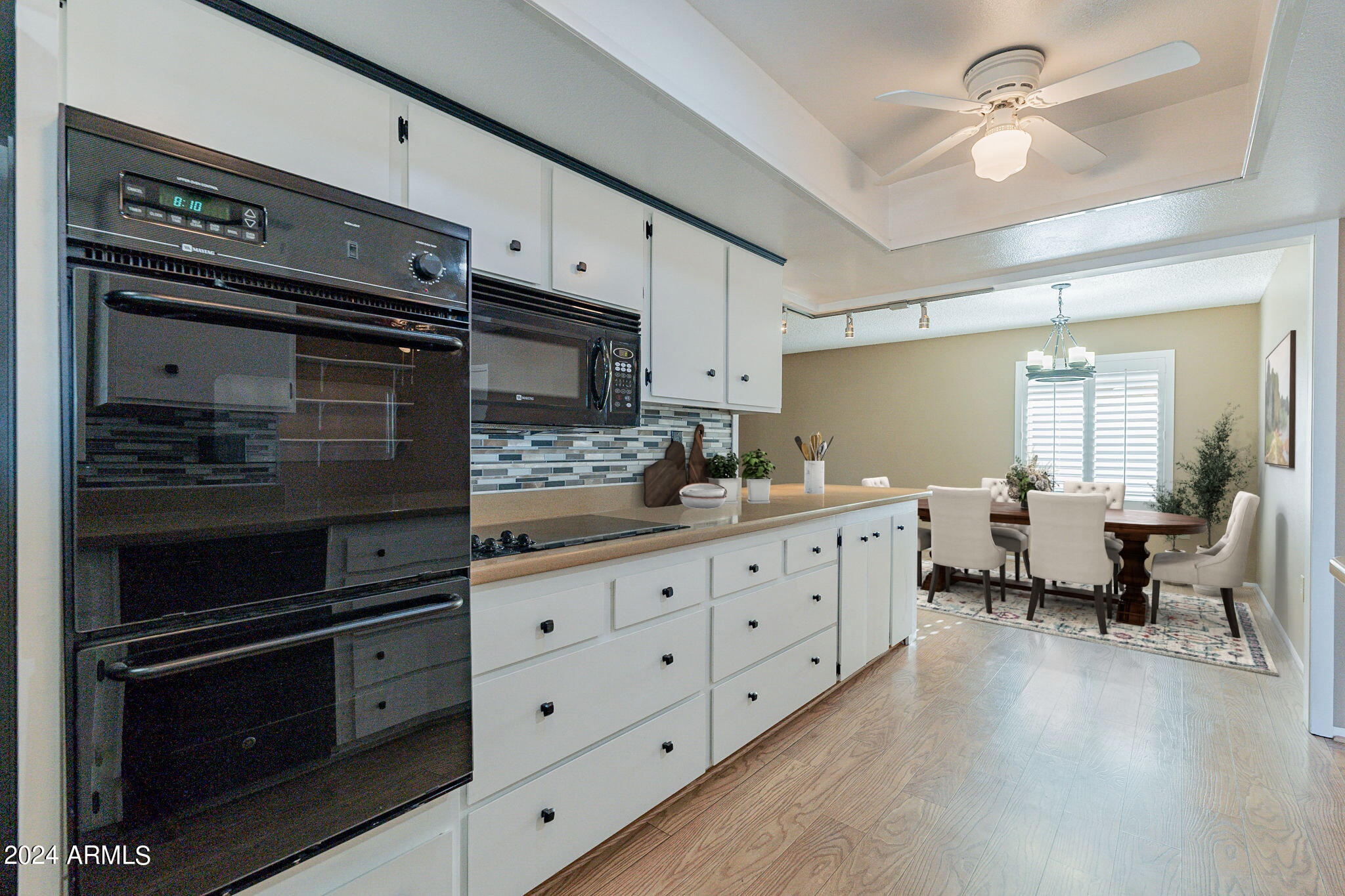 9510 West Greenway Road Sun City, AZ 85351 - Photo 5 of 46 a kitchen with stainless steel appliances white cabinets and a stove top oven